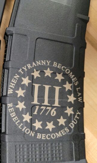 DESCRIPTION The next-generation 3percenter 1776 Magpul  Laser Engraved Magpul PMAG 30 AR15 GEN M3 is a 30-round polymer magazine for AR15/M4 compatible weapons chambered in 5.56x45 NATO / .223 Remington. Along with expanded feature set and compatibility, the GEN M3 incorporates new material technology and manufacturing processes for enhanced strength, durability, and reliability that exceed rigorous military performance specifications. While the GEN M3 is optimized for Colt-spec AR15/M4 platforms, modified internal and external geometry also permits operation with a range of additional weapons, such as the HK® 416/MR556A1/M27 IAR, British SA-80, FN® SCAR™ MK 16/16S, and others. Similar to the MOE® PMAG, the GEN M3 features a long-life USGI-spec stainless steel spring for commonality, a four-way anti-tilt follower, constant-curve internal geometry for reliable feeding, and simple tool-less disassembly for easy cleaning. The PMAG 30 GEN M3 also includes a redesigned bolt catch notch in the rear of the magazine that provides increased bolt catch clearance, while an over-travel stop on the spine helps ensure the magazine will not over-insert on compatible weapons. Low profile ribs and new, aggressive front and rear texture give positive control of the GEN M3 in all environments, and a paint pen dot matrix has been added to the bottom panel of the body to allow easy marking for identification. The new, easy to disassemble flared floorplate aids extraction and handling of the magazine while providing improved drop protection, but is slightly slimmer than before for better compatibility with tight double and triple magazine pouches. An included pop-off impact / dust cover can optionally be used to minimize debris intrusion and protect against potential damage to the top cartridge during storage and transit. Made in the U.S.A. Magazine Restricition apply in Terms and conditions Check out our Laser Engraved Mags